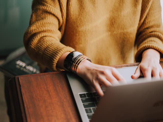 Person typing on a keyboard